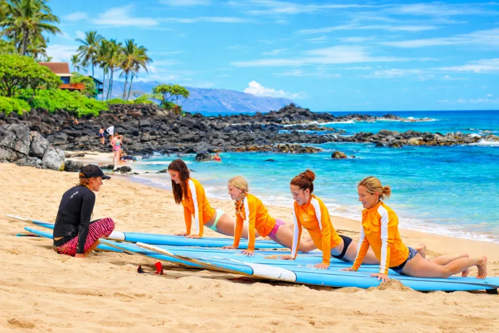 Multiple surfers catching waves during group lesson
