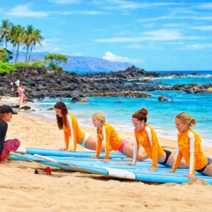 Multiple surfers catching waves during group lesson