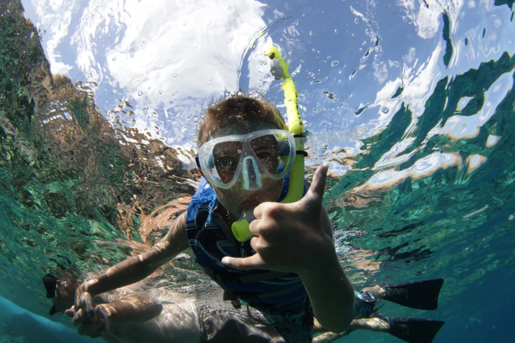 Couple snorkeling in clear Maui ocean waters