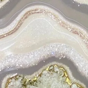 Artist creating epoxy resin geode painting in class