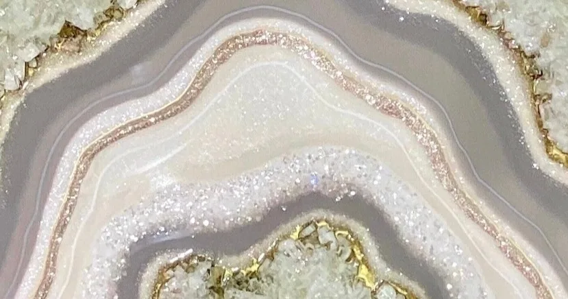 Artist creating epoxy resin geode painting in class