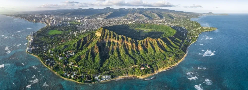Shuttle bus heading towards Diamond Head crater at sunrise