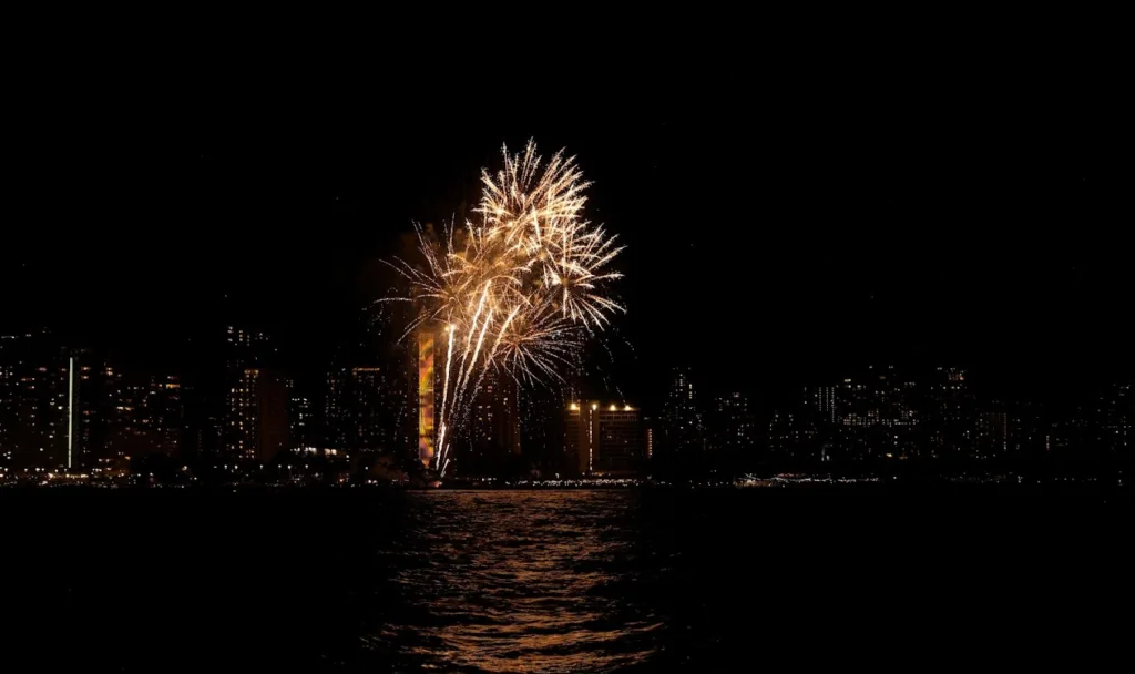 Boat cruising near Waikiki with fireworks in background