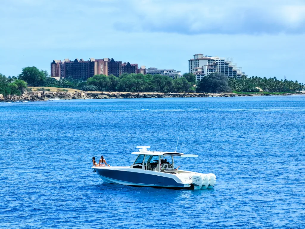 Luxury private charter boat docked at Ko Olina marina at sunset