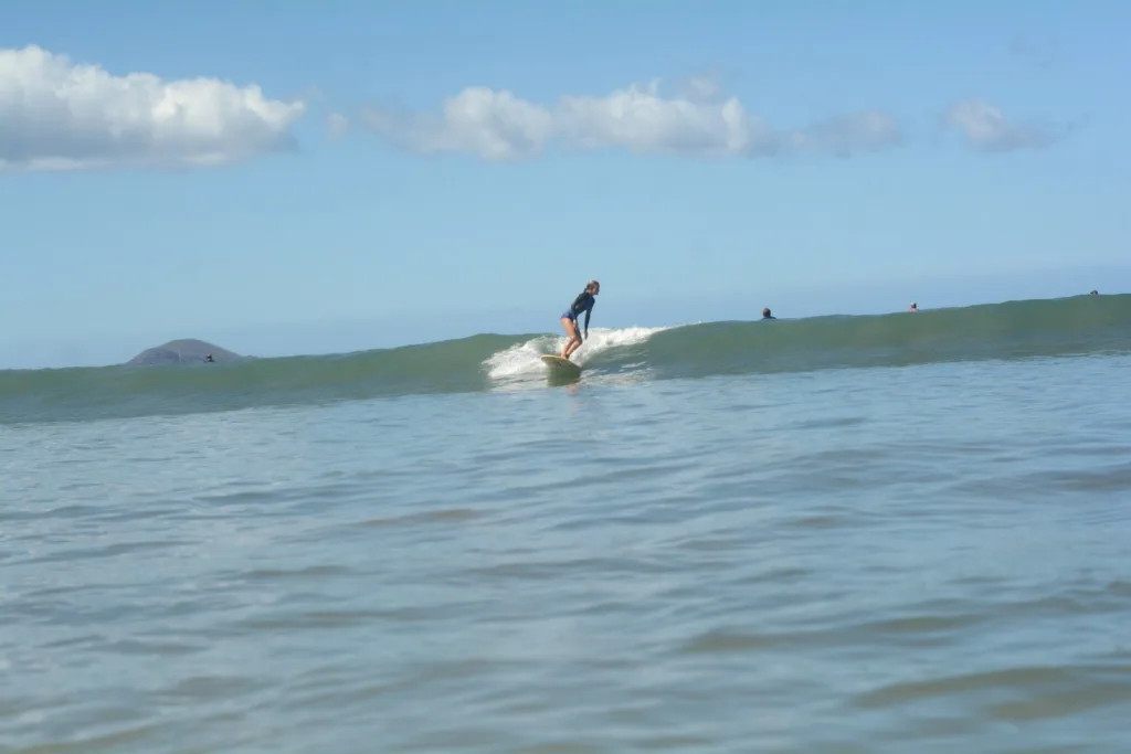Surfer catching waves during three-day progression course