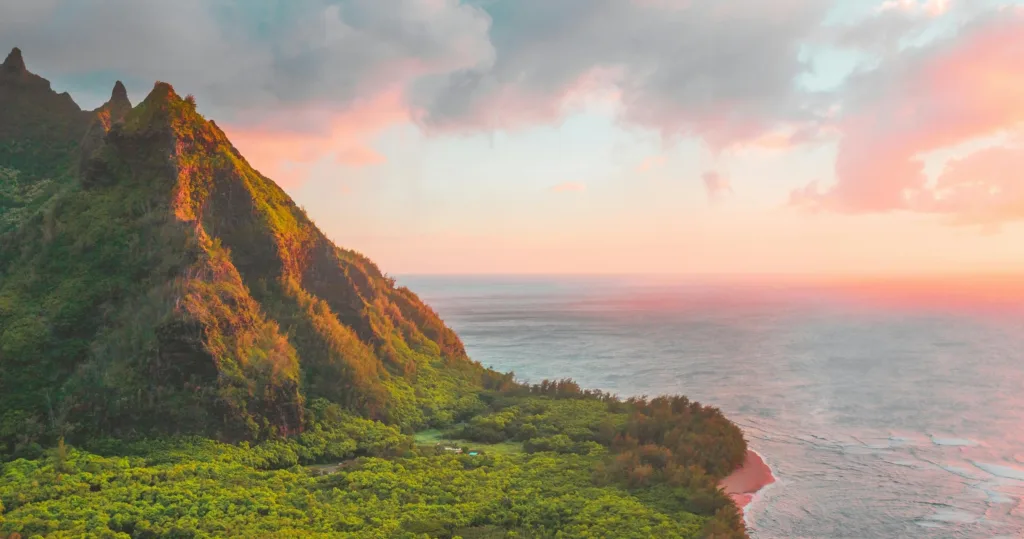 Boat cruising along Nāpali coast during golden hour