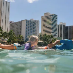 Surfers catching waves on South Shore beach in Waikiki