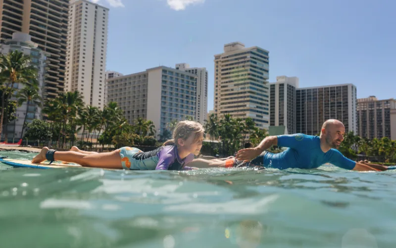 Surfers catching waves on South Shore beach in Waikiki