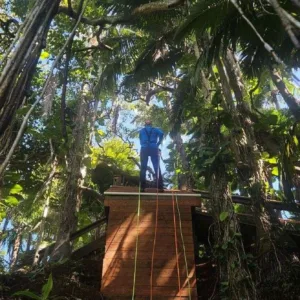 Adventurers rappelling down waterfall at basecamp
