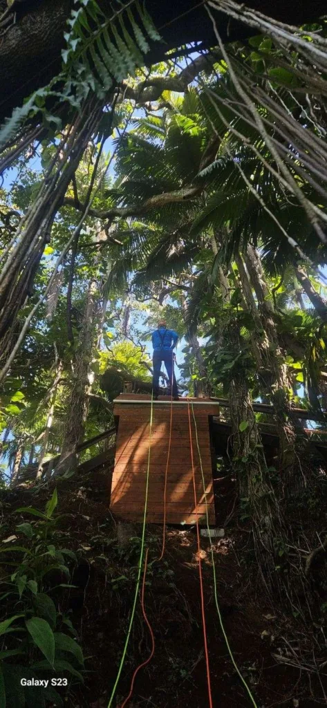 Adventurers rappelling down waterfall at basecamp