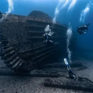Scuba diver investigating the Seatiger shipwreck underwater