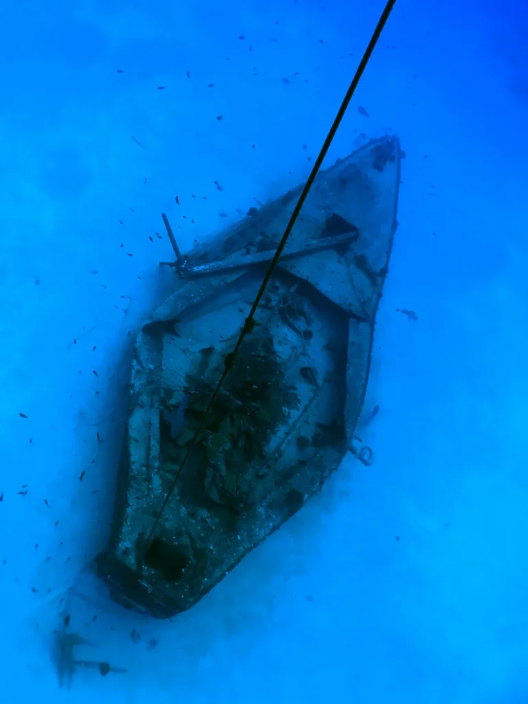 Diver exploring the sunken shipwreck at Kailua Bay