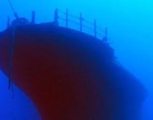 Divers exploring a lava tube underwater cave