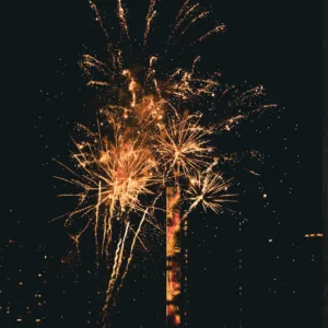 Nighttime harbor fireworks lighting up the sky in Waikiki