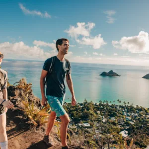 Cyclist riding e-bike along Lanikai beach trail