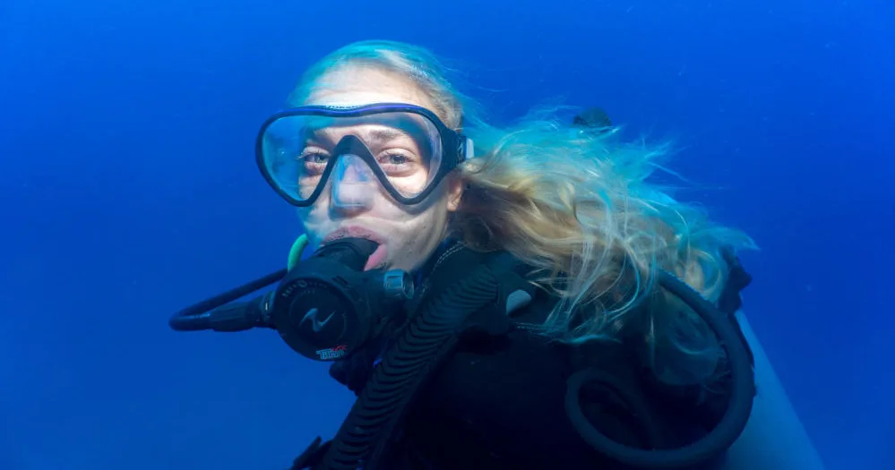 Advanced scuba divers exploring deep ocean environment