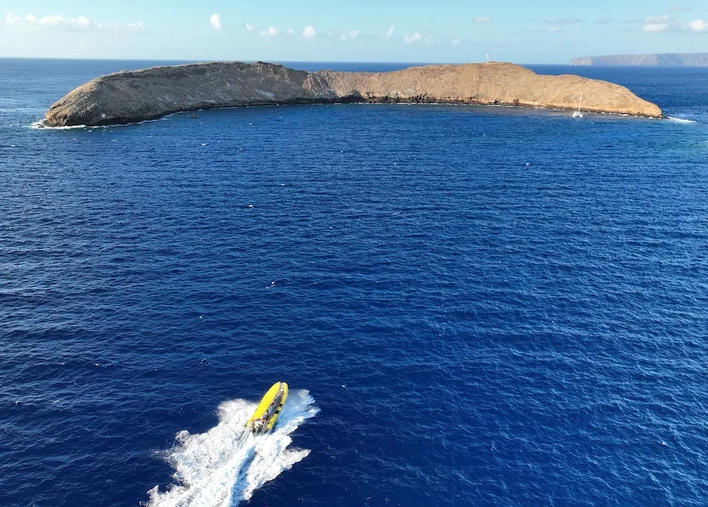 Snorkelers swimming above Molokini’s crystal clear waters