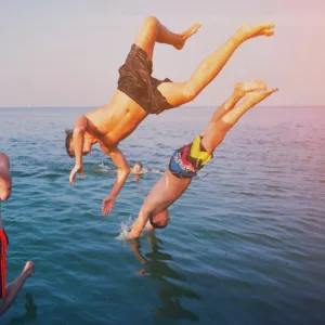 Guests enjoying a private sunset swim with whales nearby