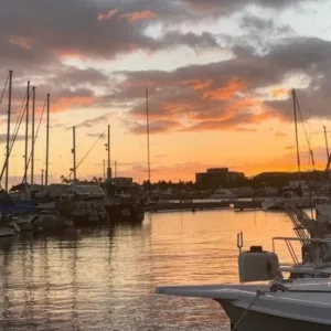Couple watching sunset from private boat in Waikiki