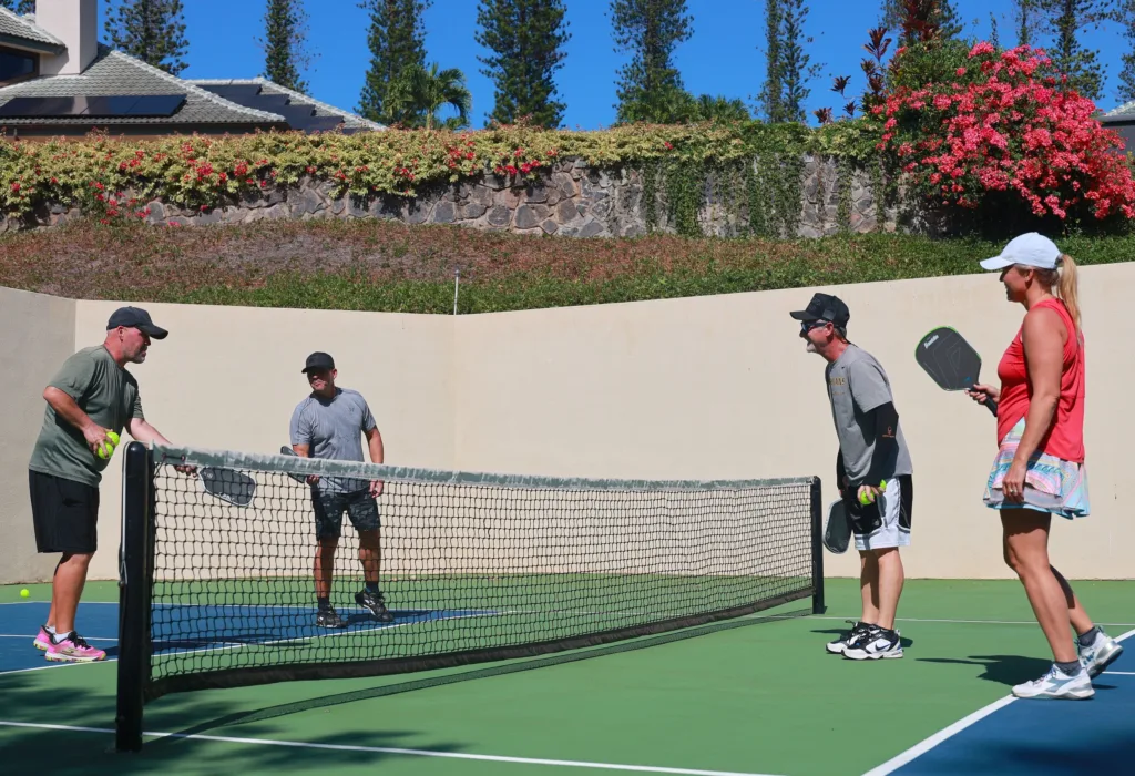 Players practicing advanced pickleball techniques on outdoor court