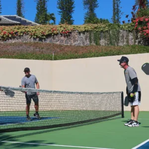 Players practicing advanced pickleball techniques on outdoor court