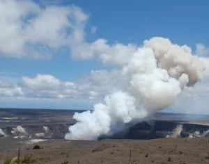 Hikers exploring volcanic landscape with steam vents