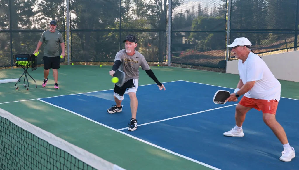 Intermediate liveball players in mid-game on island field