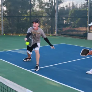 Intermediate liveball players in mid-game on island field