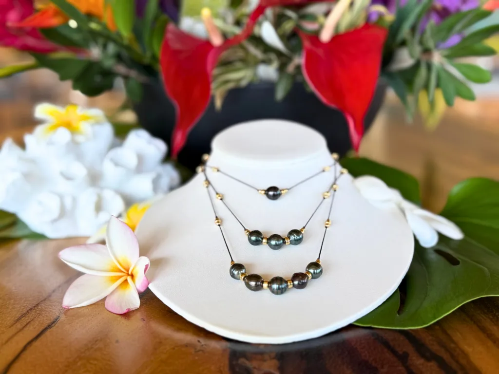 Participants crafting Tahitian black pearl necklaces by hand