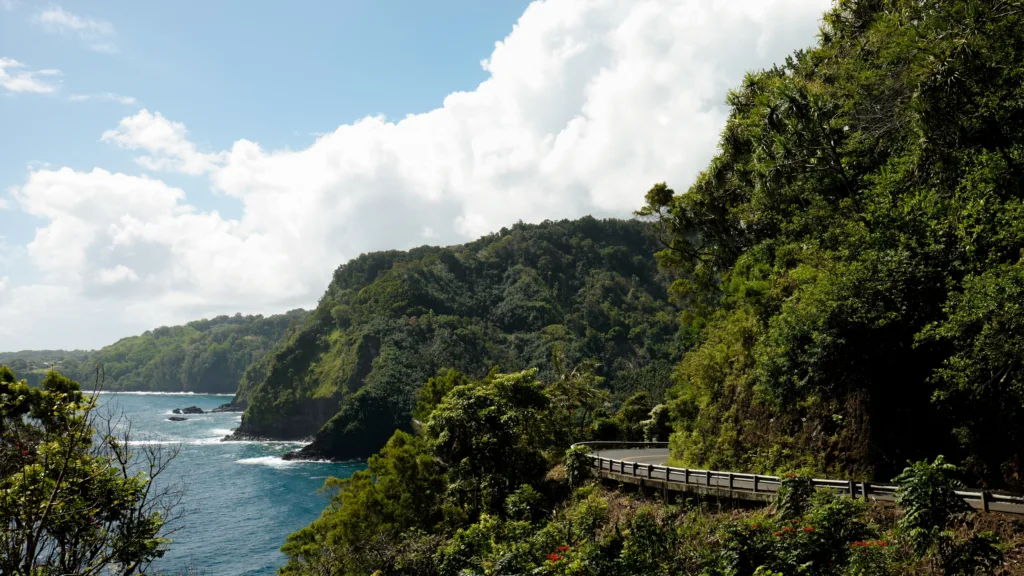 Luxury SUV driving along scenic Road to Hana route
