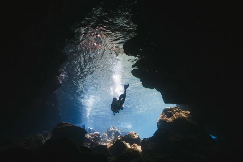 Scuba diver exploring vibrant coral reef underwater