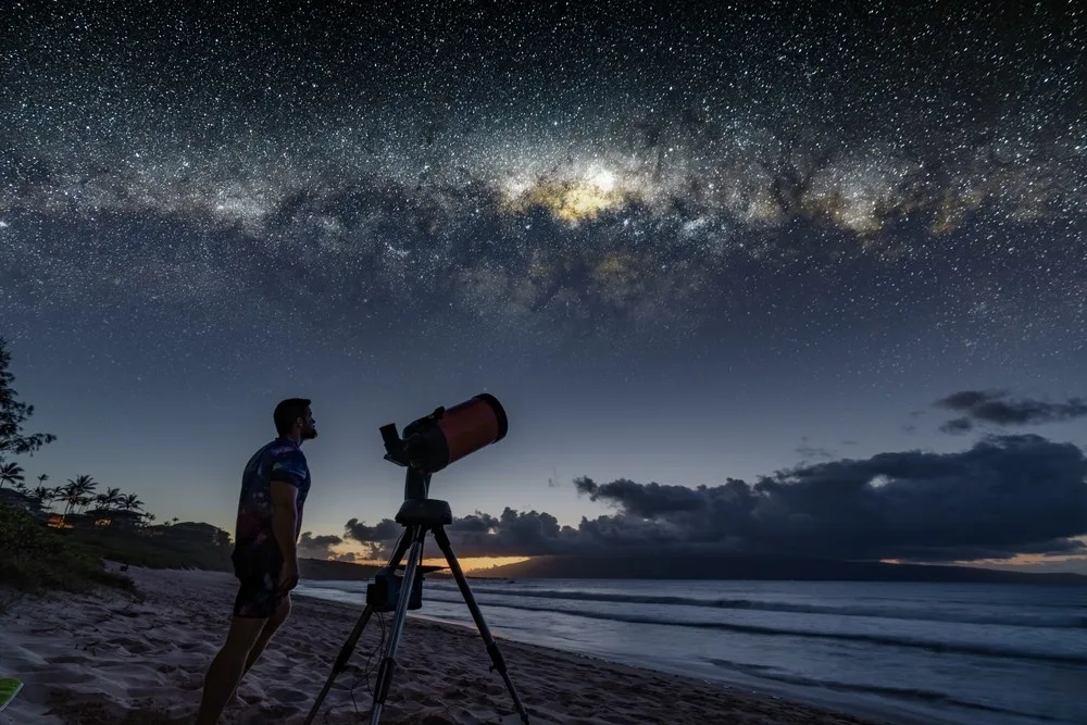 Couple stargazing under clear night sky on private tour