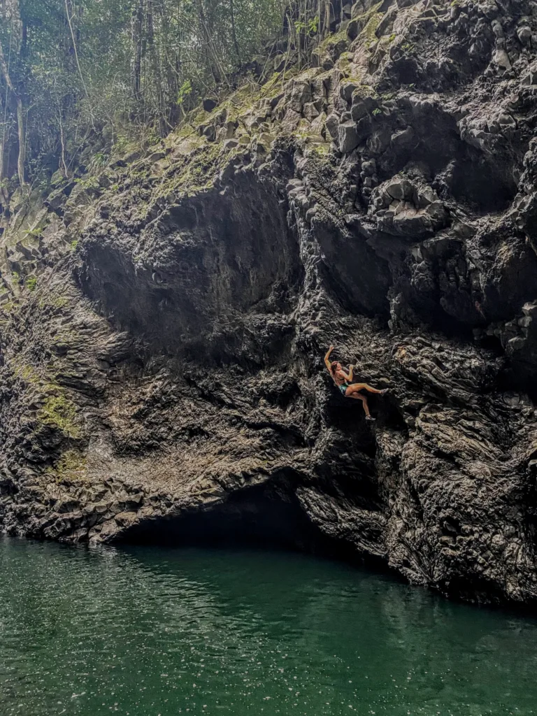 Climber scaling a rock face on Big Island