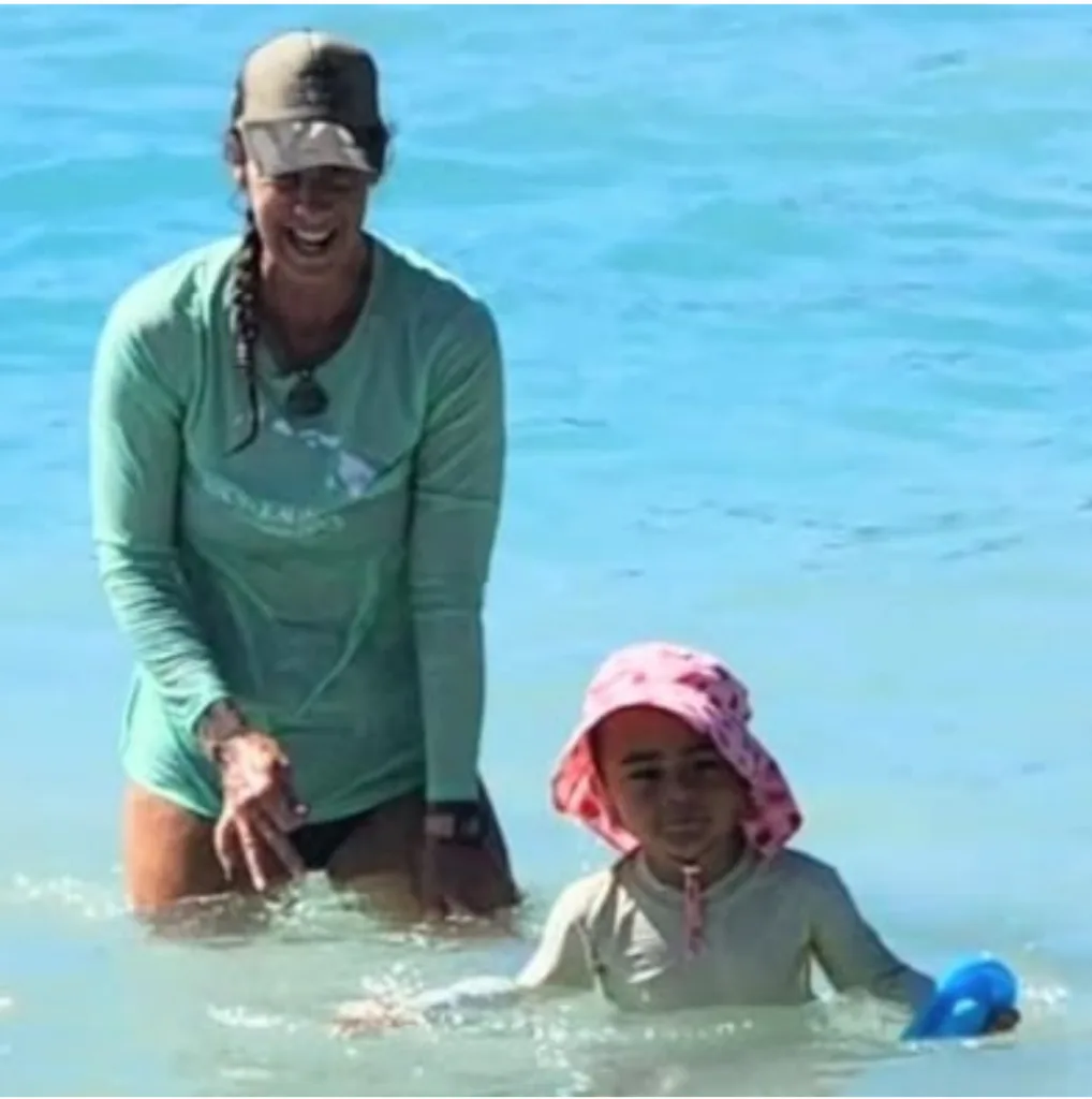 Young child learning to swim in a calm pool setting