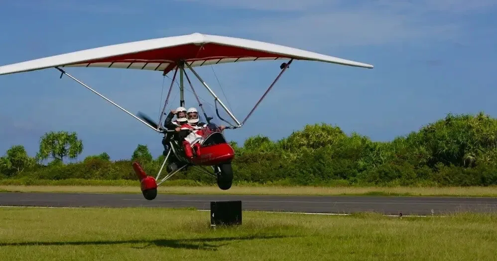 Thrilling powered hang gliding experience over tropical landscapes