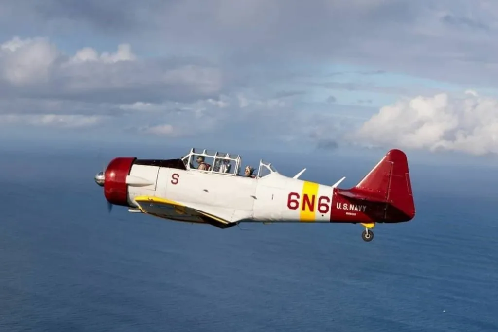 Warbird aircraft flying low over Pearl Harbor waters