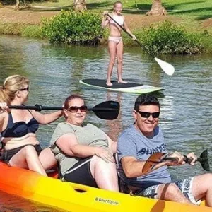 Person paddling a kayak on calm water