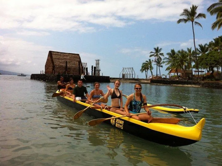 Riding traditional Hawaiian outrigger canoes along Kona coast