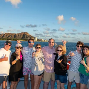 Boat cruising past Diamond Head at sunset
