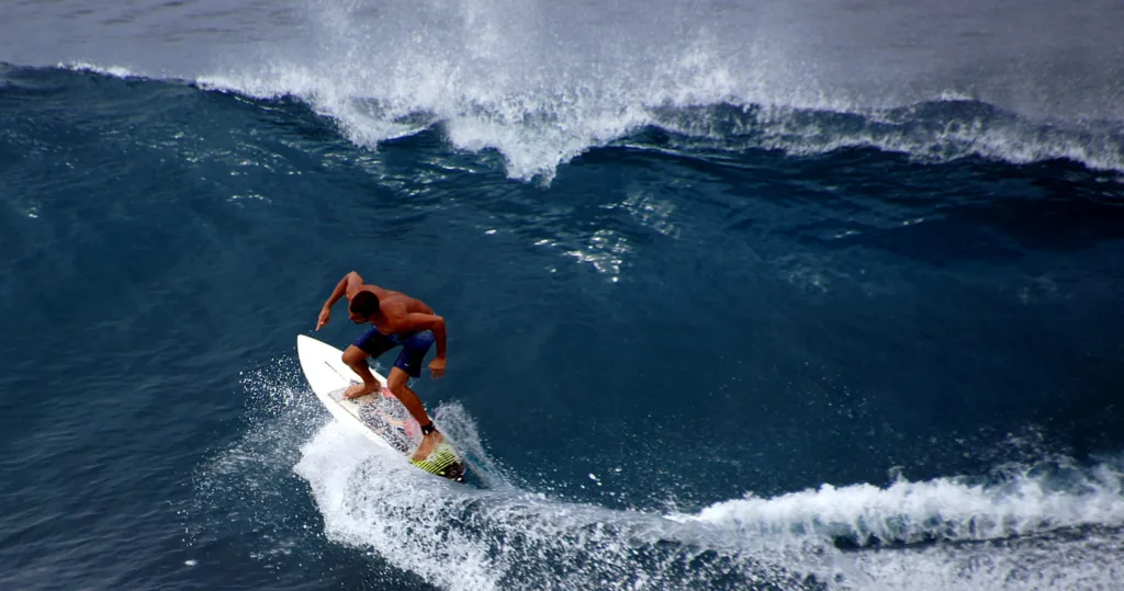 Surfer catching wave during Surf Maui 101 beginner lesson