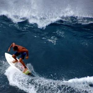 Surfer catching wave during Surf Maui 101 beginner lesson