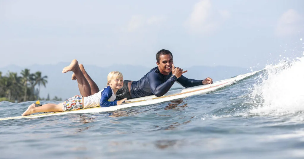 Instructor giving one-on-one private surf lesson
