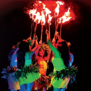 Performer spinning fire sticks during Ahi Lele show Kauai
