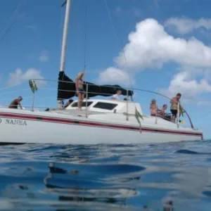 Sailboat cruising with snorkelers ready for morning adventure