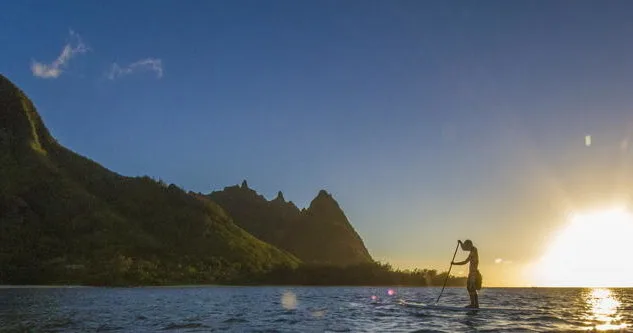 Learning stand up paddleboarding on calm Anini Beach waters