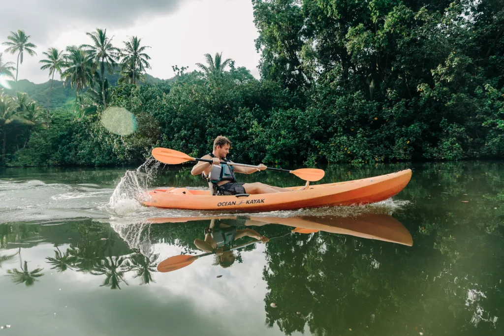 Self-guided kayak tour through lush Hawaiian rainforest waterways