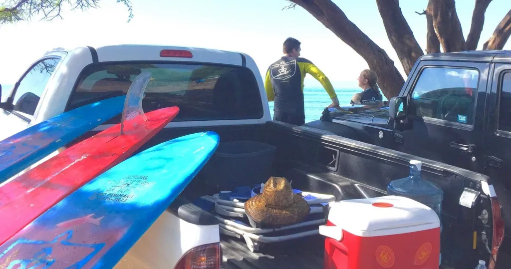 Surfers riding waves during a Royal Hawaiian Surfari
