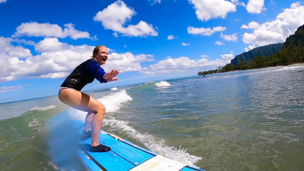 Instructor giving private surf lesson at sunset beach