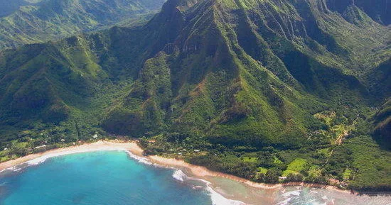 Small airplane flying over island landscapes during a custom air tour