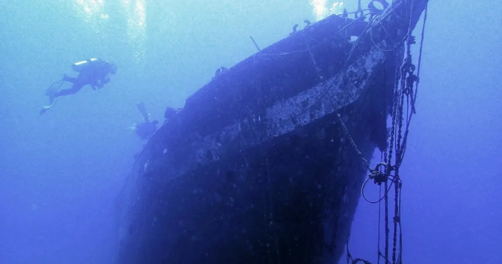 Diver exploring Carthaginian shipwreck underwater